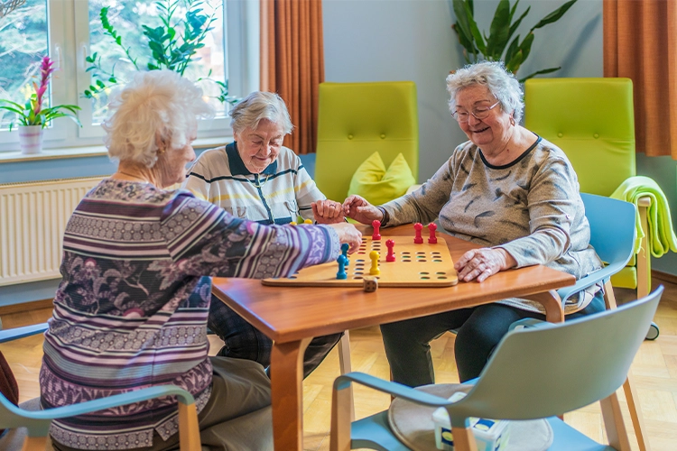 Seniorinnen spielen gemeinsam ein Brettspiel